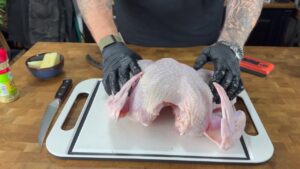 Flattening the turkey after removing its backbone