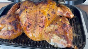 Lemon pepper turkey smoking on the Woodfire grill